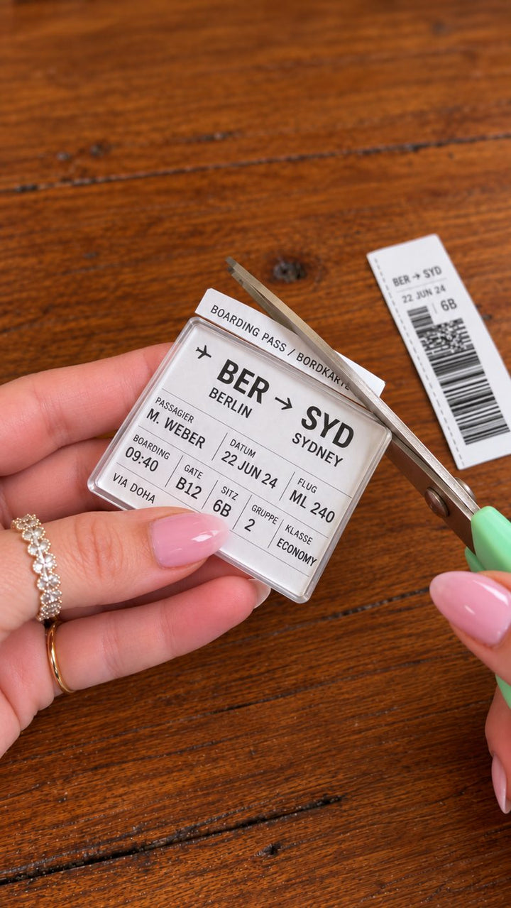 Trimming the ticket around the acrylic with scissors